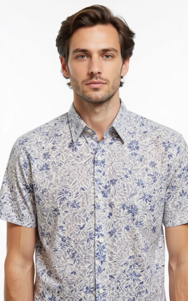 A French model wearing a Geometric pattern   printed shirt, against a white background, in a front   facing bust portrait